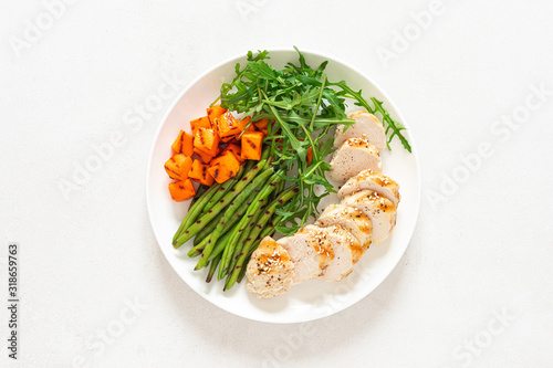 Grilled chicken breast, fillet with butternut squash or pumpkin, green beans and fresh arugula salad, healthy food, top view photo