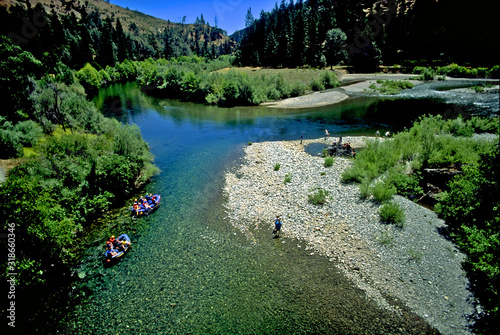 Rafters on  off-channel area of the Trinity River, California. Others explore rocky gravelbar  photo