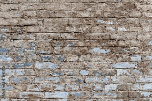 Old vintage shabby brick wall with peeling plaster. Grungy loft texture  background.