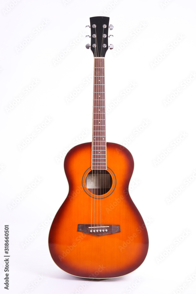 Folk style parlor acoustic guitar isolated on white background with a lot of copy space for text. Studio shot of travel size musical instrument. Close up.