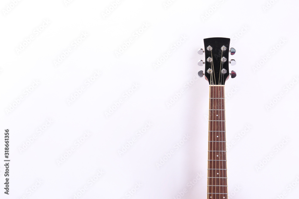 Fototapeta premium Folk style parlor acoustic guitar isolated on white background with a lot of copy space for text. Studio shot of travel size musical instrument. Close up.