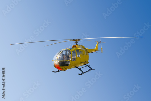 Flying yellow rescue helicopter