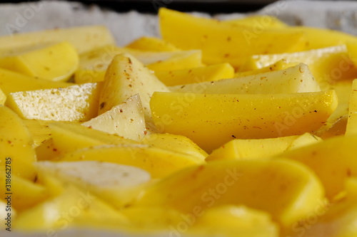 Heap fresh yellow raw peeled potatoes sliced or cut into pieces