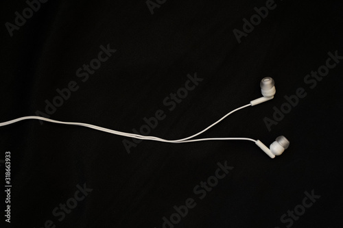 headphones from a smartphone on a black background, flatlay