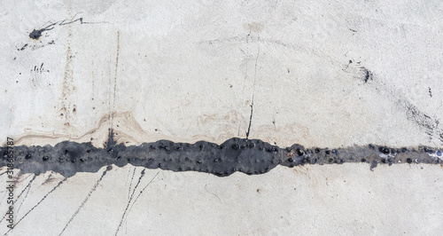 Asphalt in the groove on the concrete road With straight lines