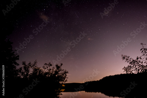 night summer autumn view lake river starry sky under the stars picnic bonfire September October sparks bonfire burns fire forest tree pine spruce cedar