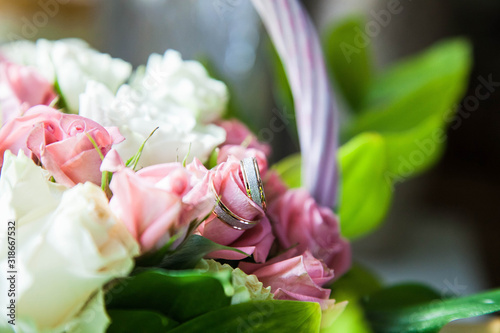 wedding precious ring of the bride and groom in a chic bouquet of flowers