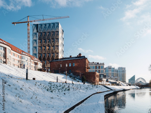 Modern view of the Yekaterinburg city with a Iset river and embankment along the river. Contemporary building construction place