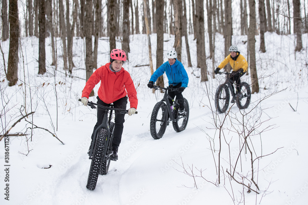 Group of friends riding their fat bike in the snow in Ontario, Canada