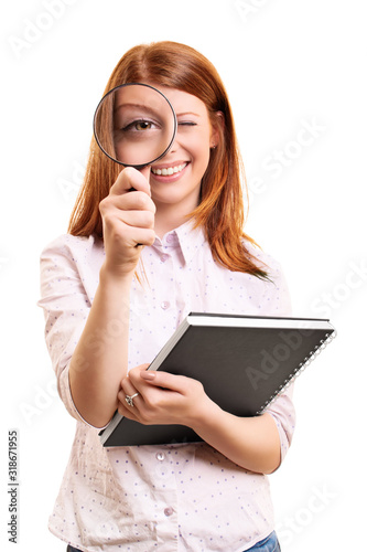 Young student girl looking through a magnifying glass