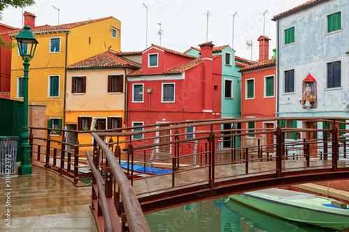 Venice landmark, Burano island canal, colorful houses church and boats, Italy. © slava2271