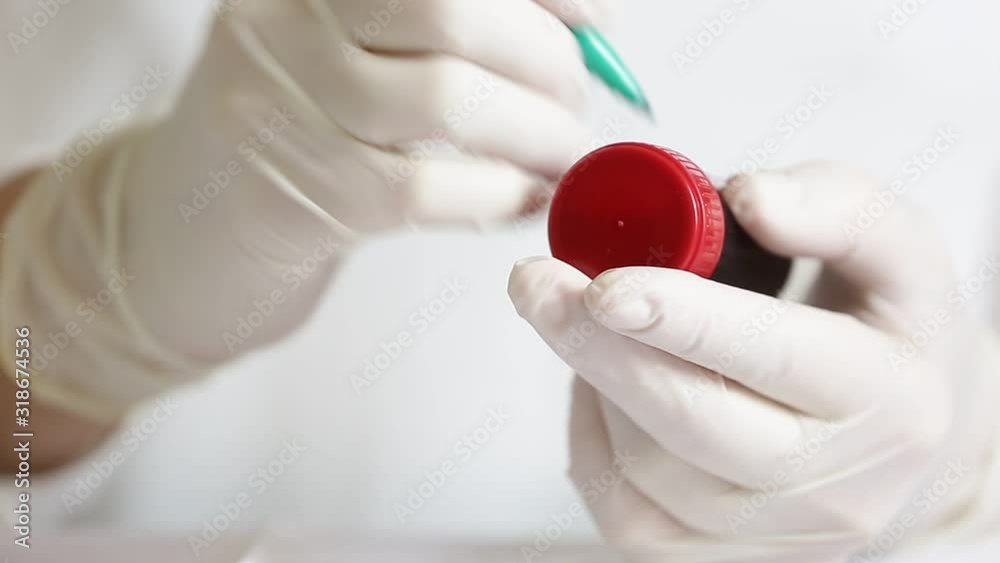 Doctor, laborant indicates ampoule of blood with koronavirus infection, disease