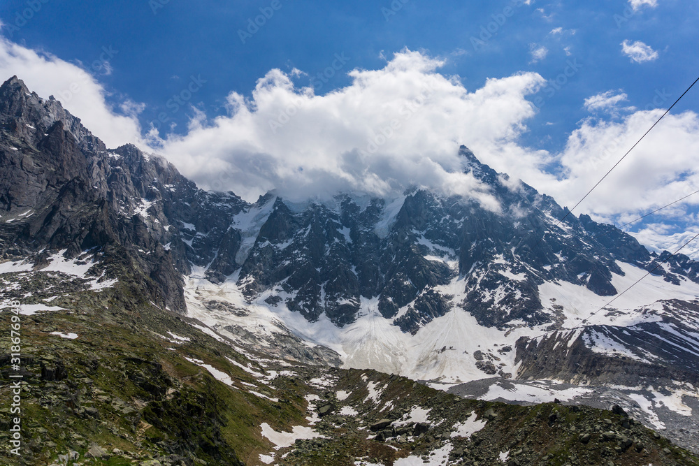 Aiguille du Midi among the clouds. Mont Blanc massif. Alps. Aiguille du Midi among the clouds. Mont Blanc massif. Alps.