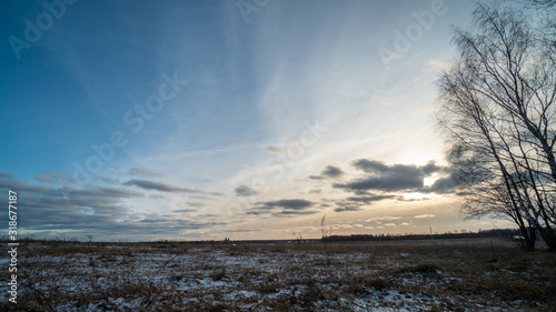 Beautiful setting sun over frozen field