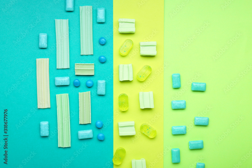Different chewing gums on color background