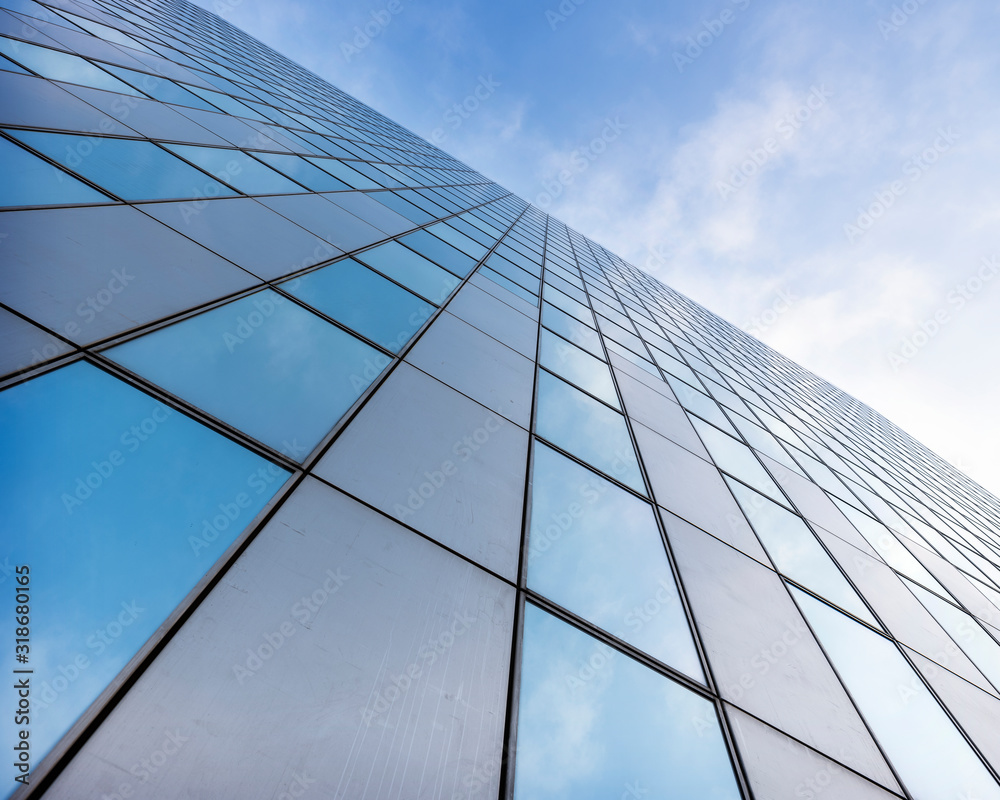 glass facades of modern office buildings and reflection of blue sky