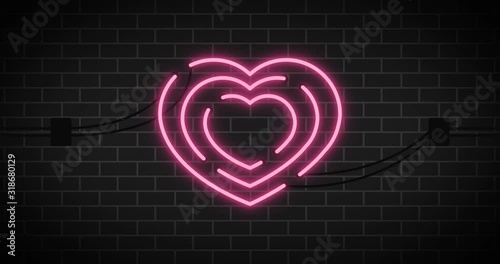 Pink neon heart.Valentine sign on brick background.