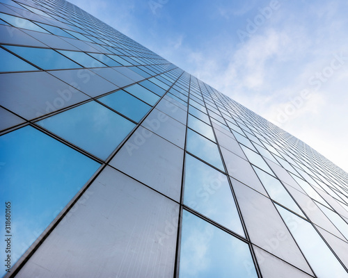 glass facades of modern office buildings and reflection of blue sky