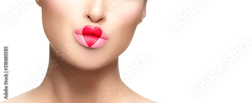 Close-up on female model face with heart painted on pink fleshy lips. Valentines day