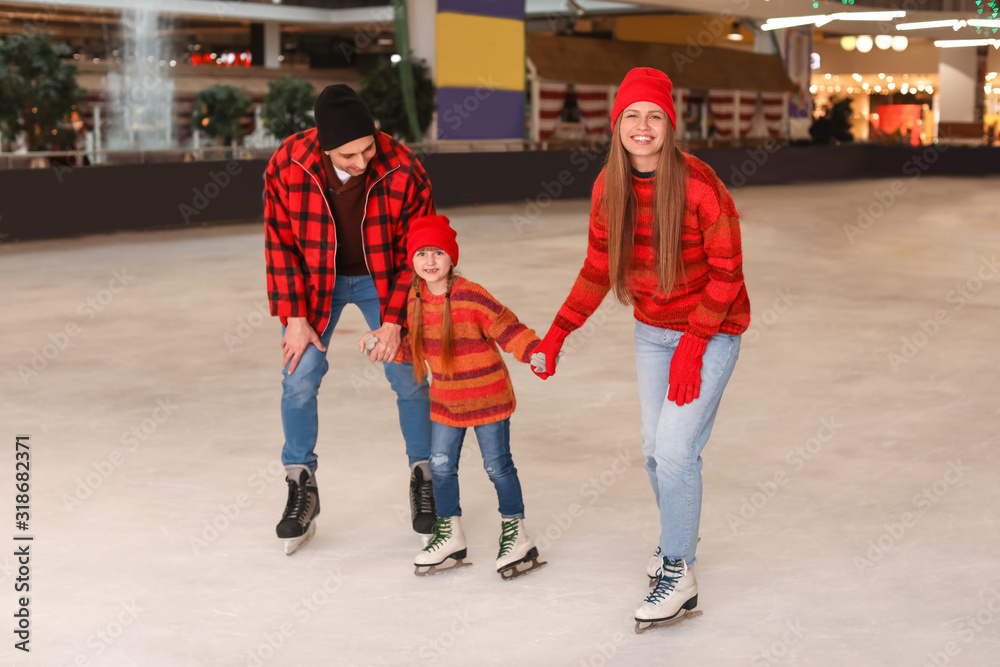 Happy family on skating rink