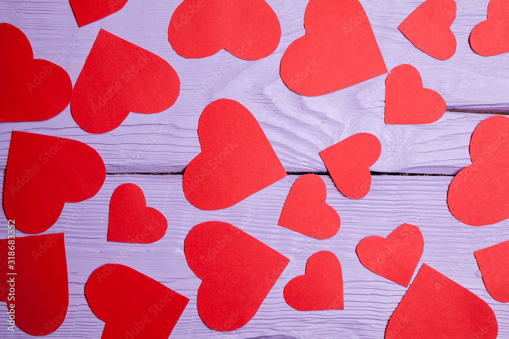 Red hearts on a lilac wooden background Red hearts on a lilac wooden background