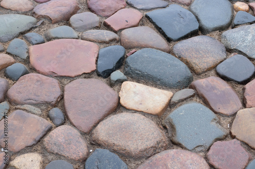 Cobblestone road. Multicolored cobblestone texture. modern road