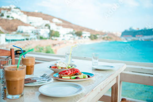 Healthy breakfast in outdoor cafe with sea view