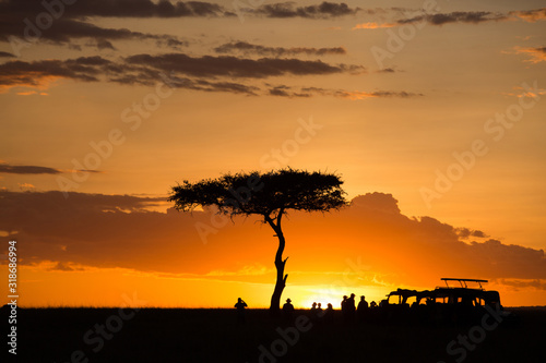 Fototapeta Naklejka Na Ścianę i Meble -  Tourists enjoying evening tea during Sunset at Masai Mara