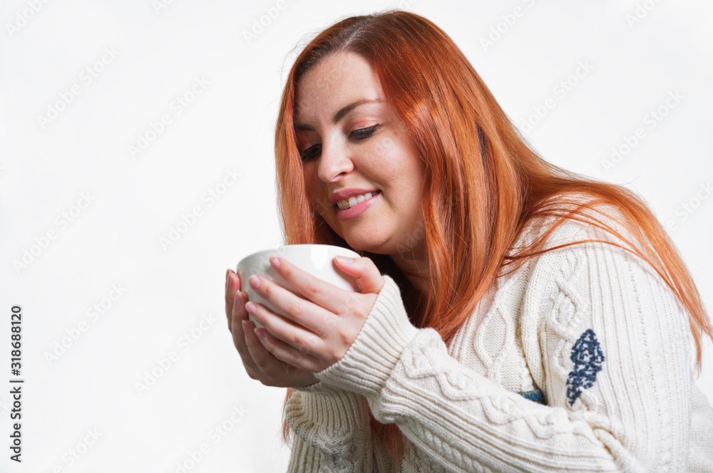 A woman with freckles drinking coffee A woman with freckles drinking coffee