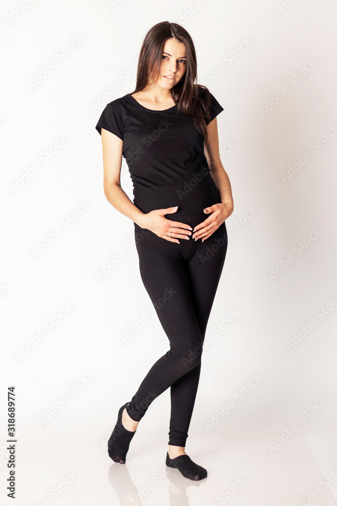 Pregnant young girl look at her belly on a white background. Isolate Pregnant young girl look at her belly on a white background. Isolate