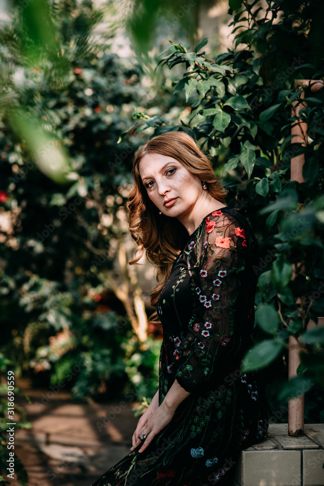 Smiling woman in the botanic garden