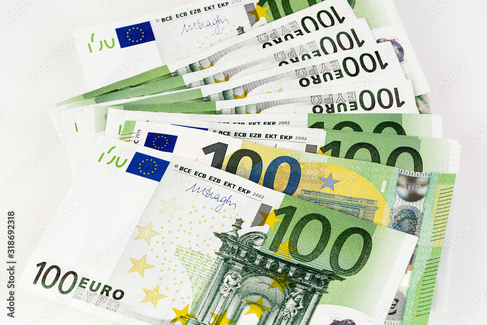 Close-up of 100 Euro banknoteson white background Close-up of 100 Euro banknoteson white background