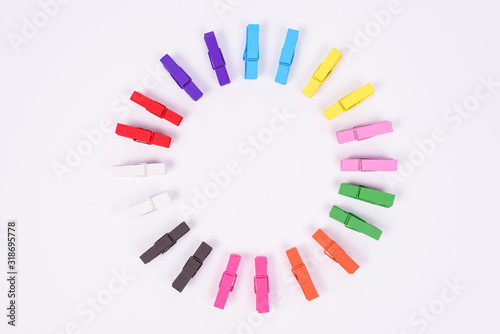 High angle view studio photo of nice colorful mini clothespins isolated on white table background wall