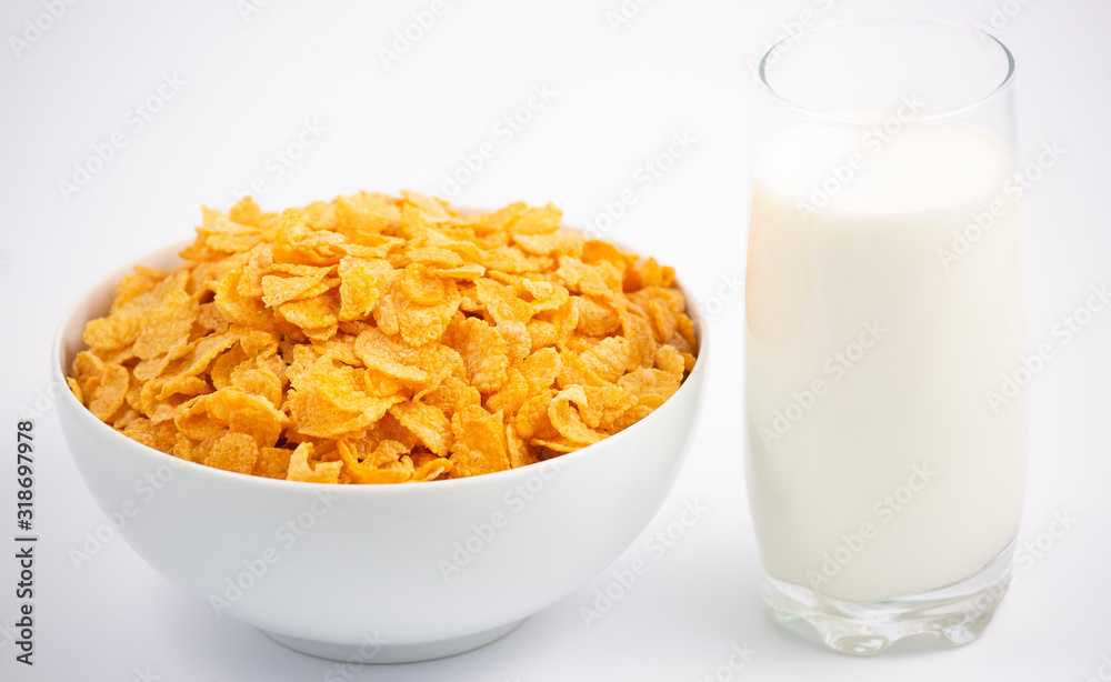 Natural corn flake breakfast cereal in cups and milk is a healthy breakfast that is good for your body every day on a white background. Natural corn flake breakfast cereal in cups and milk is a healthy breakfast that is good for your body every day on a white background.