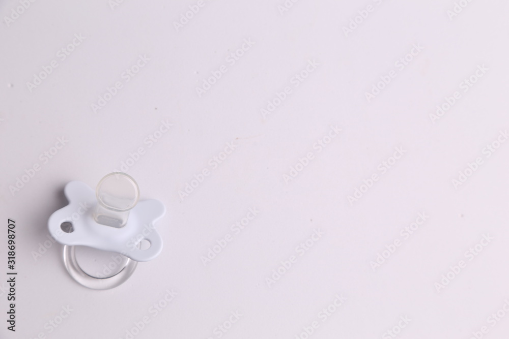 white pacifier in color background white pacifier in color background