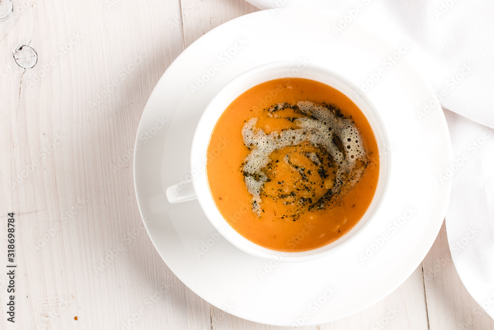 Winter spicy lentil cream soup on light airy background