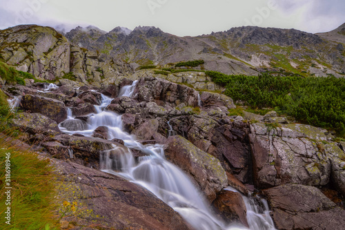 between the rocks of the mountain stream below the ridge