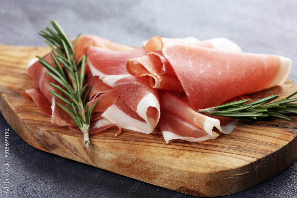 Dry Spanish ham, Jamon Serrano, Bellota, Italian Prosciutto Crudo or Parma ham. meat cutting