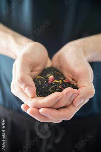  a bunch of leaf tea lies in the hands