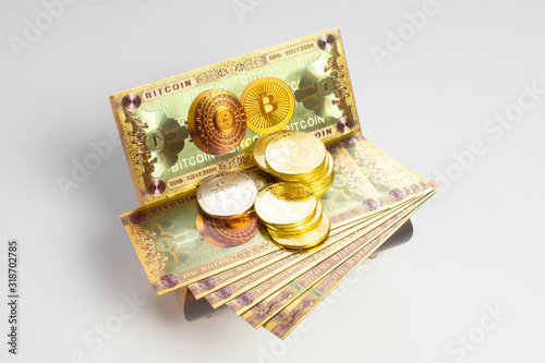 Bitcoin banknotes and golden btc coins on the treasure trove, cryptocurrency in wooden chest, gift, decoration on white paper background. photo