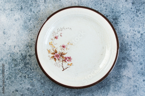 Antique porcelain plate on concrete