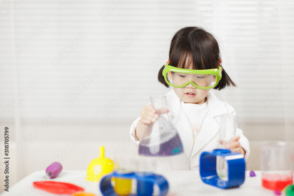 toddler girl pretend play scientist role at home against white background toddler girl pretend play scientist role at home against white background