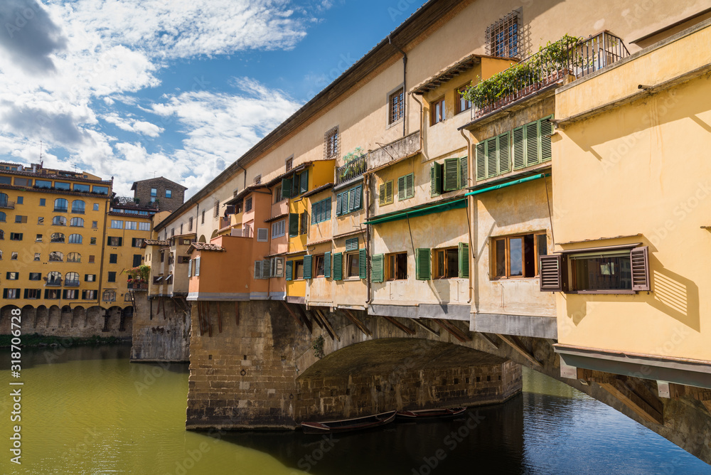 Ponte Vecchio in historical center downtown in Florence during a sunny day with historical old buildings Ponte Vecchio in historical center downtown in Florence during a sunny day with historical old buildings