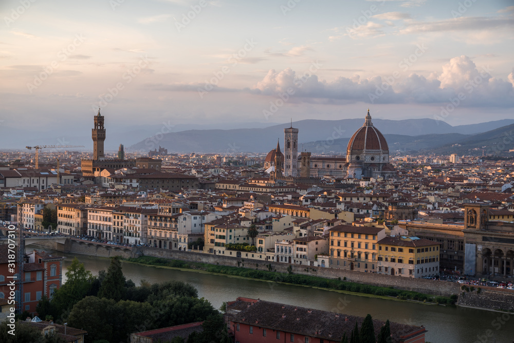 Florence romantic panoramic view from above during a coloured sunset on buildings Duomo churches and Ponte Vecchio
