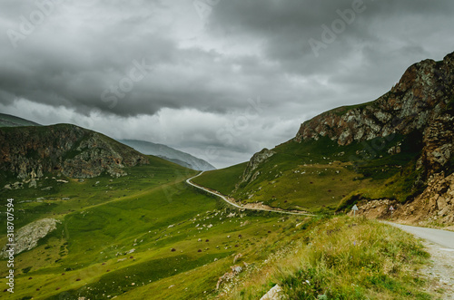 Cycling mountain road. Misty mountain road in high mountains.. Cloudy sky with mountain road