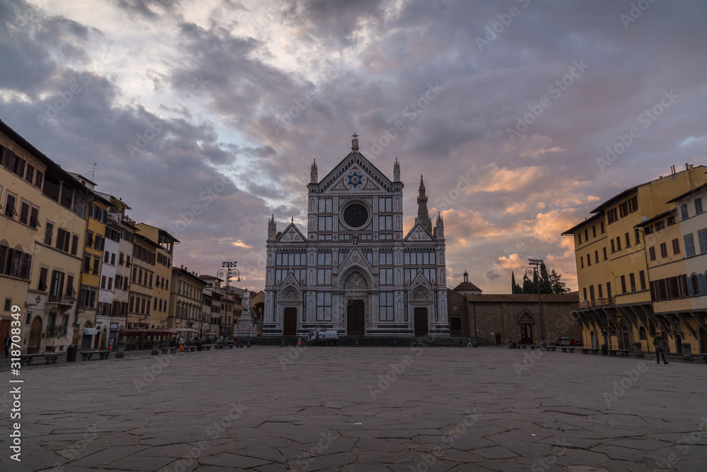Church of Santa Croce in Florence in Tuscany in Italy during the sunrise with empty square and orange clouds