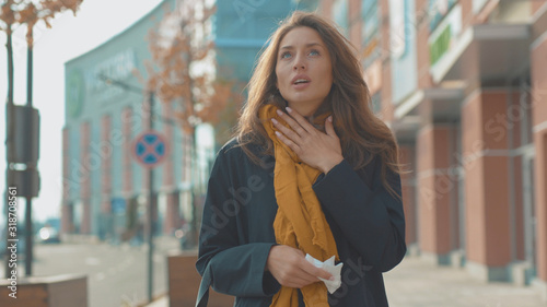 Face young woman stand sneezing coughs feel sick at outdoor fever cold allergy city beautiful disease female nose lady runny tissue air pollution adult illness district slow motion © america_stock