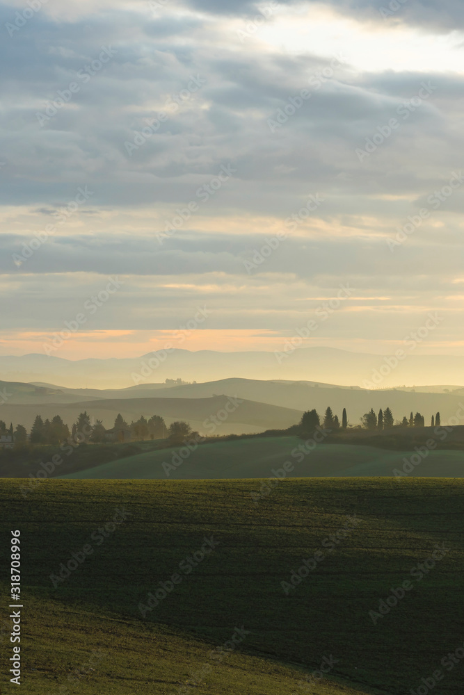 Foggy sunrise with typical landscape in Tuscany, Italy, Europe