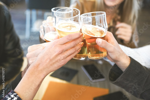 Hands holding glasses of beer and cheering with each other- Lifestyle concept