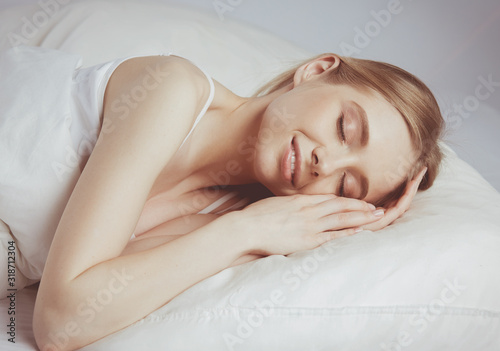 Young beautiful girl sleeps in the bedroom